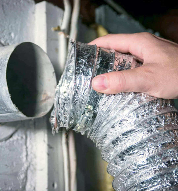 Certified technician using vacuum and brush for dryer vent cleaning in St Peters Missouri home